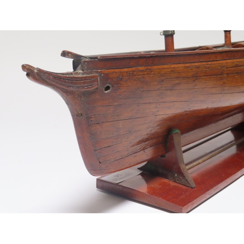 16 - A 19TH CENTURY CARPENTER'S MODEL FOR A TWO-MASTED YACHT
with planked and pinned 19in. hull and decks... 