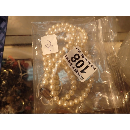 108 - Strand of faux pearls