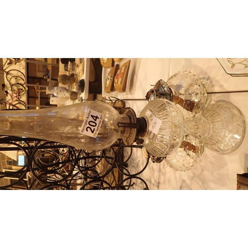 204 - Glass based oil lamp with chimney and two further glass oil lamps