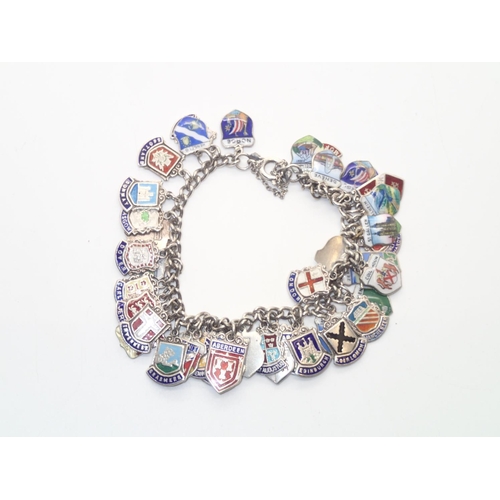 121 - Vintage Silver Charm Bracelet with 43 silver and enamel city/town shields 64g
P&P group 1 (£16 for t... 