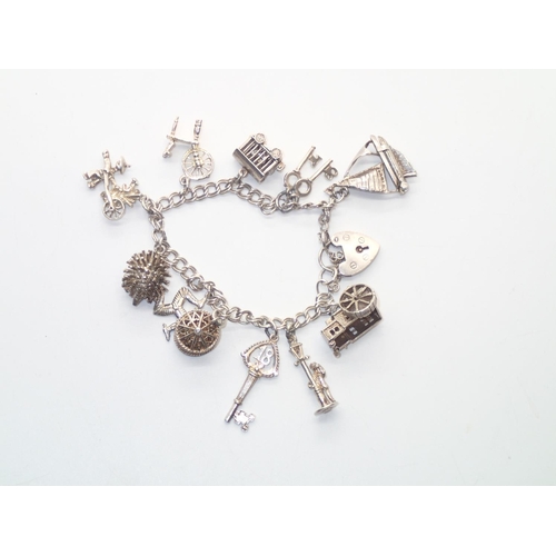 129 - Vintage Silver Charm Bracelet with 11 charms 39g
P&P group 1 (£16 for the first item and £1.50 for s... 