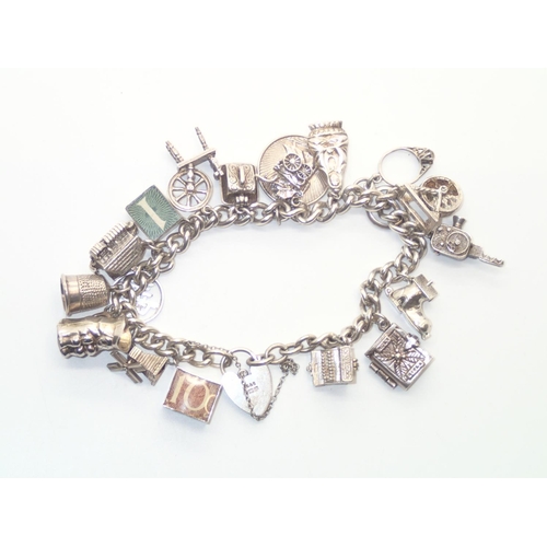 133 - Heavy Vintage Silver Charm Bracelet with 18 charms.  Includes £1 and 10 Shilling Notes and several N... 