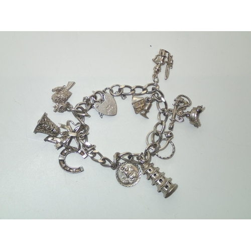 147 - Vintage Silver Charm Bracelet with 10 charms 43g
P&P group 1 (£16 for the first item and £1.50 for s... 