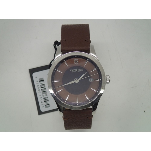 242 - Victorinox Swiss Army wristwatch on leather strap with tag, outer box, papers etc. Working at lottin... 