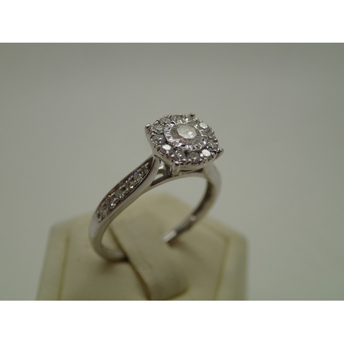 132 - Contemporary 9ct white gold halo set diamond cocktail ring with diamond shoulders totalling 0.5cts, ... 
