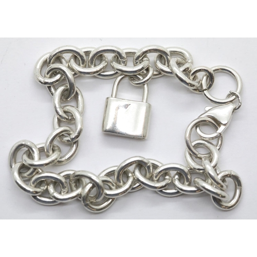 1019 - Silver heavy oval link bracelet with padlock charm, 24g. P&P Group 1 (£14+VAT for the first lot and ... 