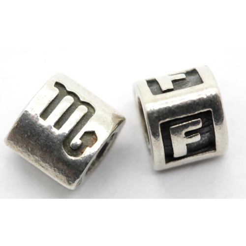 1188 - Two genuine Pandora charms stamped A.L.E, largest L: 9mm. P&P Group 1 (£14+VAT for the first lot and... 