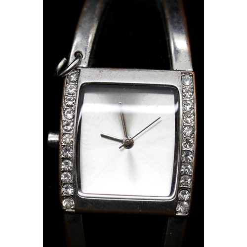 1217 - Karen Millen ladies silver plated bangle watch, boxed with papers. Requires battery, signs of loss o... 