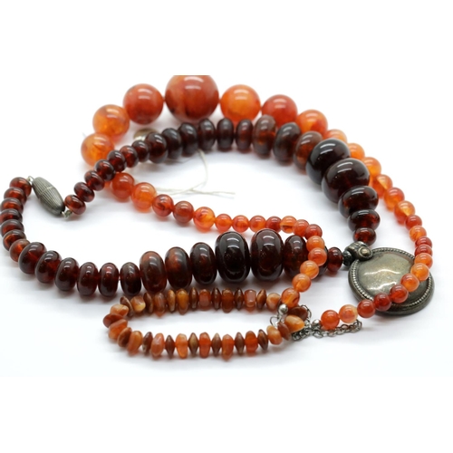 1219 - Two amber coloured bead necklaces and a similar bracelet. P&P Group 1 (£14+VAT for the first lot and... 