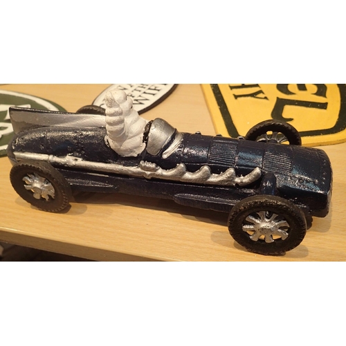 21 - Cast iron Michelin Man racing car in blue, L: 27 cm. P&P Group 2 (£18+VAT for the first lot and £2+V... 