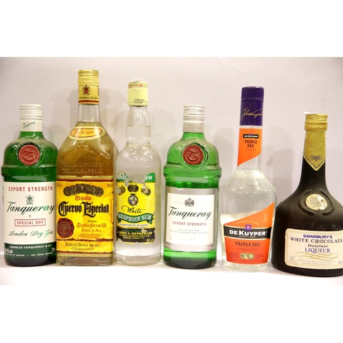 1410 - Six bottles of mixed spirits including Tequila, De Kuyper triple, Tanqueray gin, etc. Not available ... 