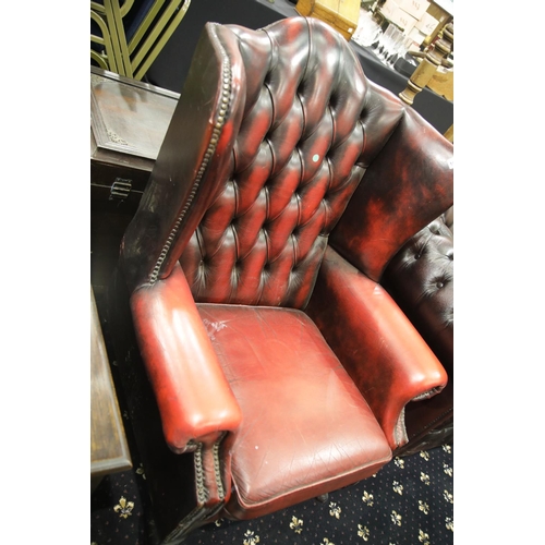 1664 - An ox-blood red leather Chesterfield wing back gentleman's armchair. This lot is not available for i... 