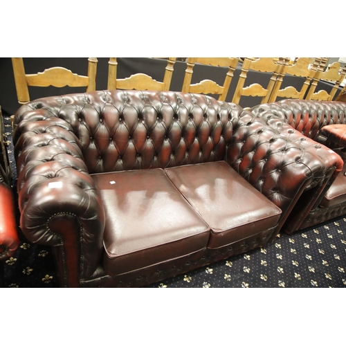 1665 - Oxblood red leather button back two seater Chesterfield sofa. This lot is not available for in-house... 