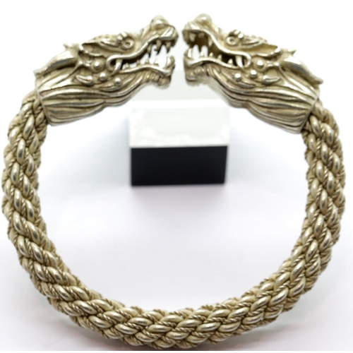 1621 - White metal Tibetan silver large dragon bangle, D: 9 cm. P&P Group 1 (£14+VAT for the first lot and ... 