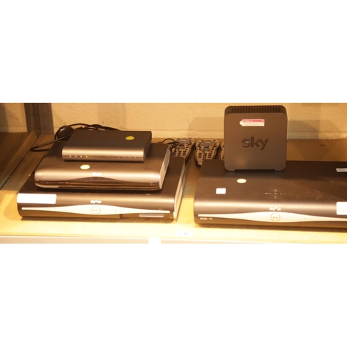 246 - Quantity of digital receivers, broadband routers and remote controls. This lot is not available for ... 