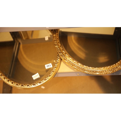 263 - Two oval wall mirrors with bevelled glass and gold frames. This lot is not available for in-house P&... 