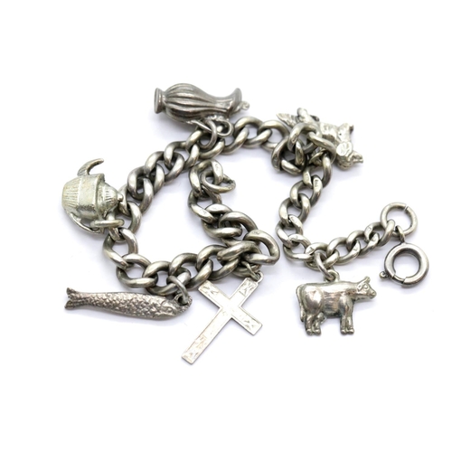 1129 - Hallmarked silver charm bracelet with six charms, L: 21 cm, 27.0g. P&P Group 1 (£14+VAT for the firs... 