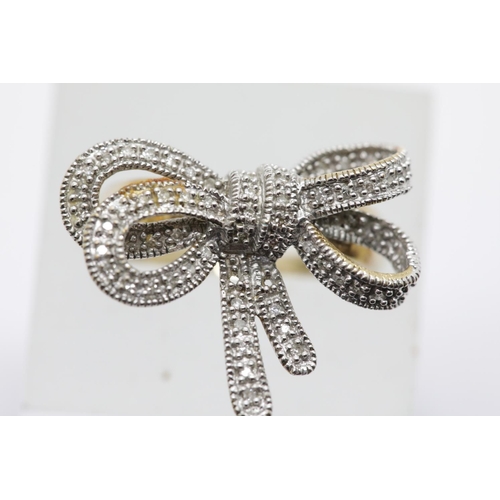 1305 - 9ct gold diamond set bow ring. Size P. 4.5g. P&P Group 1 (£14+VAT for the first lot and £1+VAT for s... 
