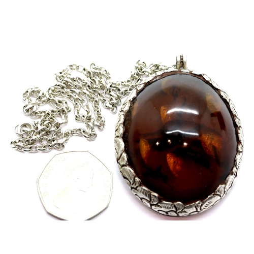 1134 - Silver and amber large pendant on a silver chain. P&P Group 1 (£14+VAT for the first lot and £1+VAT ... 