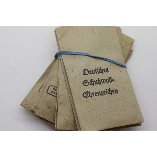 3474 - Ten German WWII type West Wall medals with ribbons in packets of issue. P&P Group 1 (£14+VAT for the... 