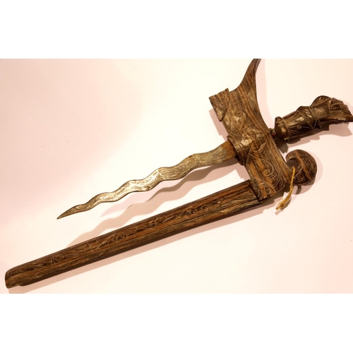 3242 - Middle Eastern kriss, blade L: 30 cm, having a heavily carved grip and scabbard. P&P Group 2 (£18+VA... 