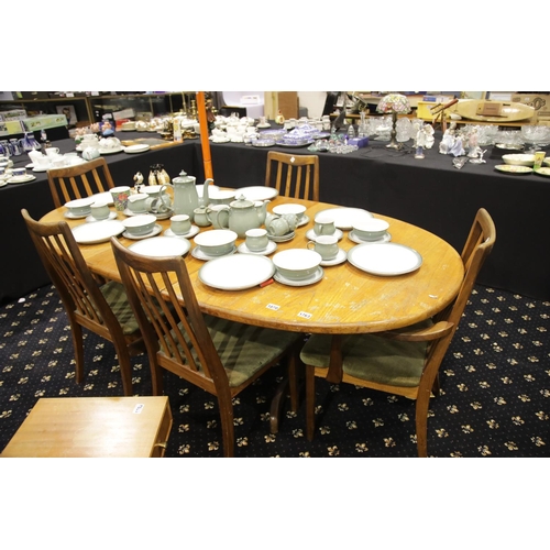 1763 - G-Plan extending oval dining table with folding leaf, with a set of five (3+2) chairs. Not available... 