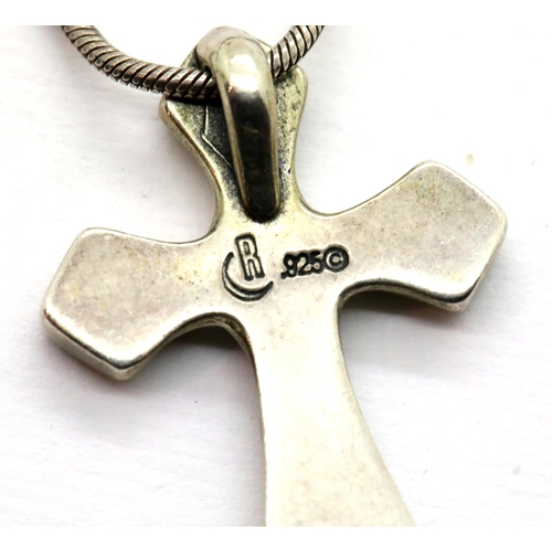 1064 - Amber set silver ring, two further silver rings and a silver cross on chain, combined 17g. P&P Group... 