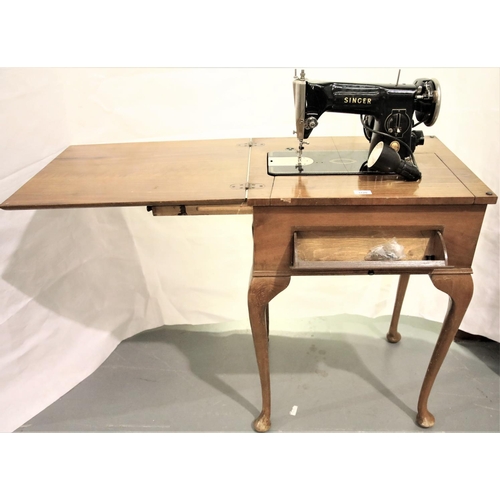 3120 - Vintage Singer sewing machine in a walnut cabinet, model 215G with lamp. Not available for in-house ... 