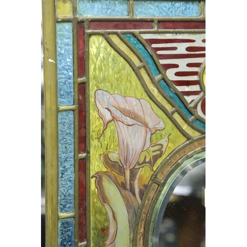 1351 - Late Victorian stained and leaded glass fire screen, having an oval bevelled mirror insert and brass... 