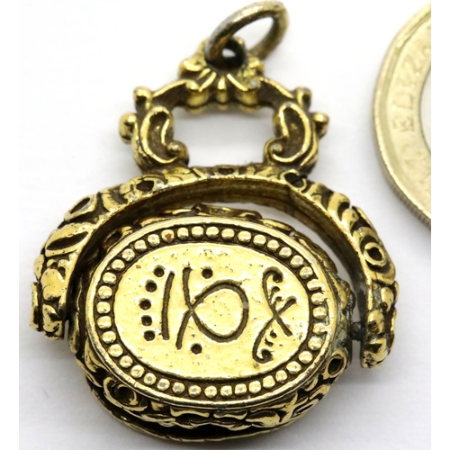 1009 - Yellow metal spinning fob with Arabic inscription, 14.5g. P&P Group 1 (£14+VAT for the first lot and... 