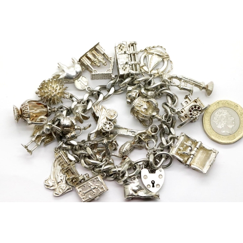 1012 - Hallmarked silver charm bracelet with 22 charms, 108g. P&P Group 1 (£14+VAT for the first lot and £1... 