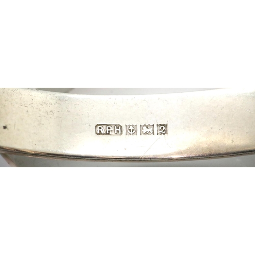1123 - Two silver bangles, one engraved with foliate design, the other bright cut. P&P Group 1 (£14+VAT for... 