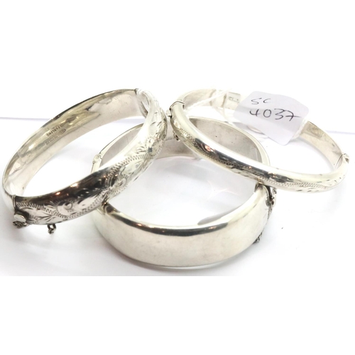 1111 - Three silver bangles, Birmingham 1964, 29g, Birmingham 1969, 12g and Birmingham 1973, 18g. P&P Group... 