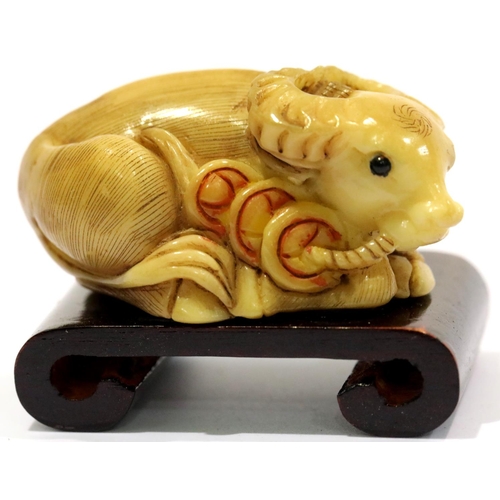 1305 - Vintage hand carved tagua nut ox, signed to base of tail, including stand. P&P Group 1 (£14+VAT for ... 