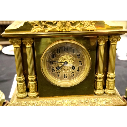 1482 - Vincent & Cie, a 19th century lacquered brass clock and garniture, each raised on velvet topped and ... 