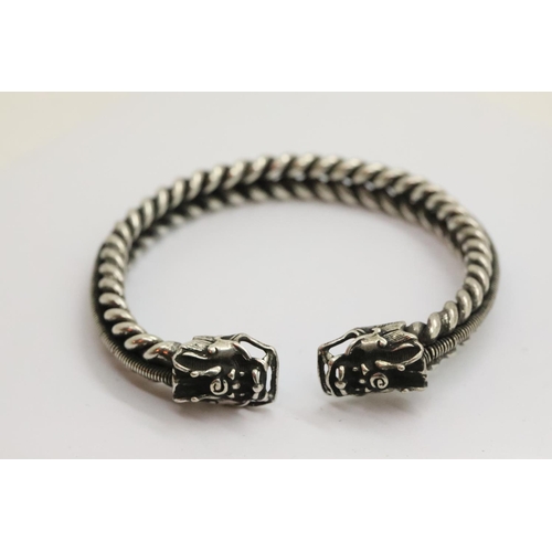 103 - White metal Tibetan silver twisted bangle with dragon finials. P&P Group 1 (£14+VAT for the first lo... 