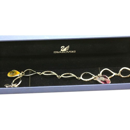 1103 - Boxed Swarovski bracelet with purple and yellow stones. P&P Group 1 (£14+VAT for the first lot and £... 