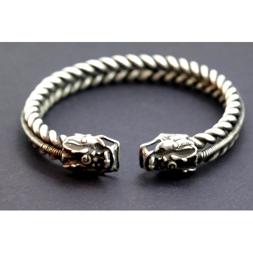 53 - White metal Tibetan silver twisted rope effect bangle with dragon head decoration. 38g. P&P Group 1 ... 