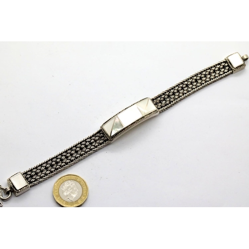 1128 - 925 silver and mother of pearl heavy bracelet, L: 19 cm. P&P Group 1 (£14+VAT for the first lot and ... 