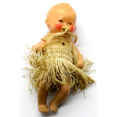 1311 - Antique German ceramic baby figurine with original clothing. P&P Group 1 (£14+VAT for the first lot ... 