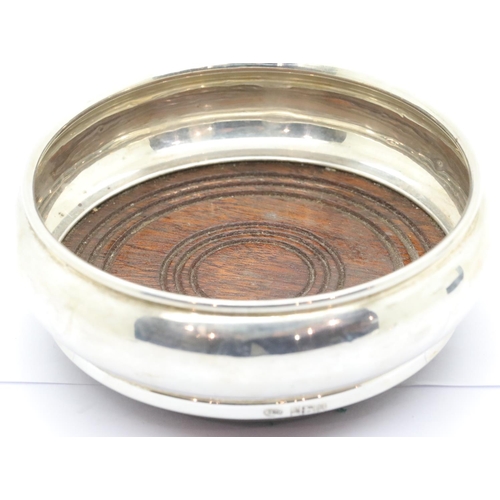 1353 - Elizabeth II hallmarked silver bottle coaster, with turned oak and green felt base. Birmingham assay... 