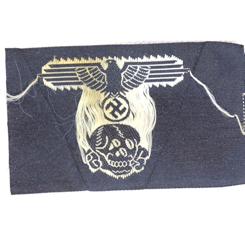 3099 - German WWII type embroidered SS cap eagle with Totenkopf skull, unused. P&P Group 1 (£14+VAT for the... 