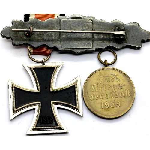 3393 - German WWII type Iron cross second class, a worn Close Combat clasp marked Peekhaus and a War Merit ... 