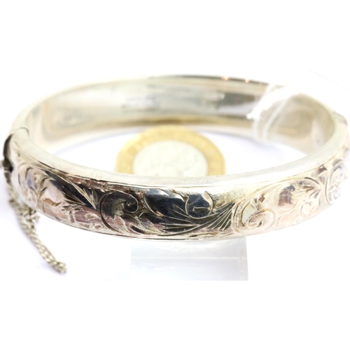 1009 - Hallmarked silver engraved bangle with safety chain, 26g. P&P Group 1 (£14+VAT for the first lot and... 