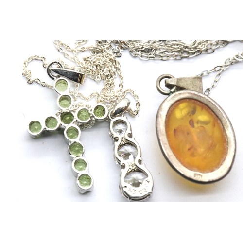 1145 - Three silver pendants on silver chains including an amber example. P&P Group 1 (£14+VAT for the firs... 