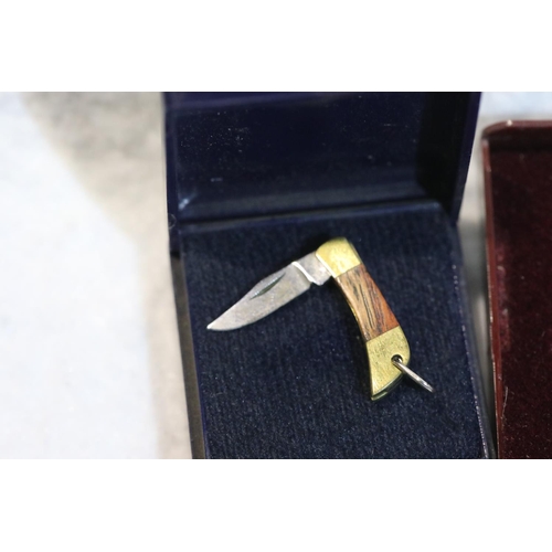 1228 - Miniature Puma folding knife (blade 16 mm) two white metal cartridge pins and a pheasant brooch. P&P... 