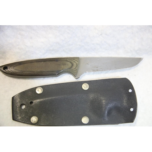 1238 - Plastic sheathed Farid elm handled hunting knife (blade length 9 cm).  P&P Group 2 (£18+VAT for the ... 