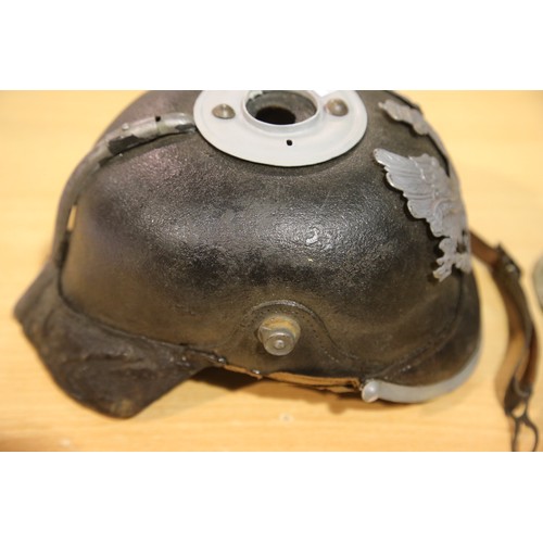 3165 - Imperial German or Prussian type pickelhaube, with leather liner (damaged) and canvas cover numbered... 