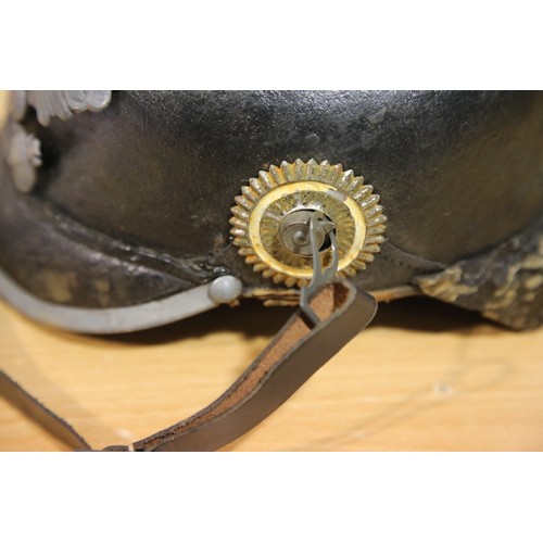 3165 - Imperial German or Prussian type pickelhaube, with leather liner (damaged) and canvas cover numbered... 