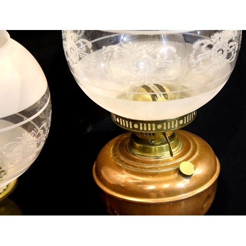 1394 - Two Victorian oil lamps in brass and copper with etched glass shades. Not available for in-house P&P... 